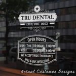Storefront open hours decal with business name, phone number, and website