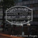Storefront open hours decal with business name, phone number, and website