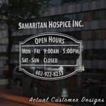 Storefront open hours decal with business name, phone number, and website
